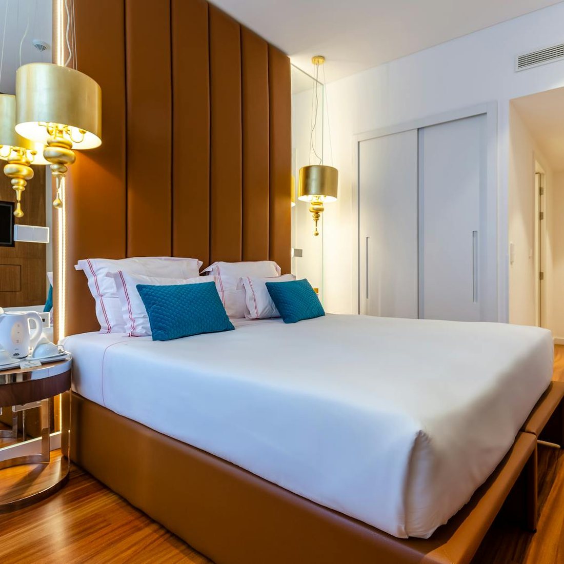 Elegant modern hotel room with warm lighting and restrained furnishings