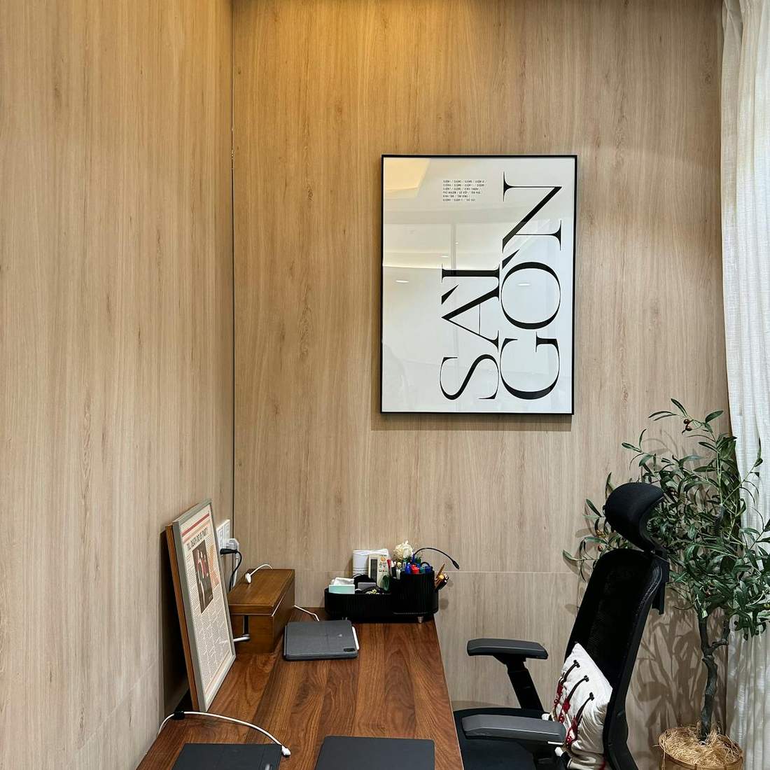 Modern hotel room with a desk, laptop, and organized workspace for business travel