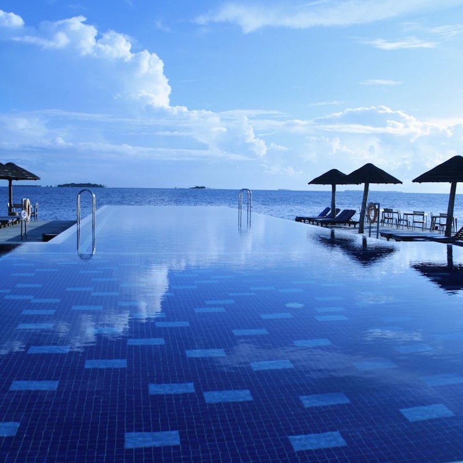 Resort swimming pool with clear blue water and open deck space