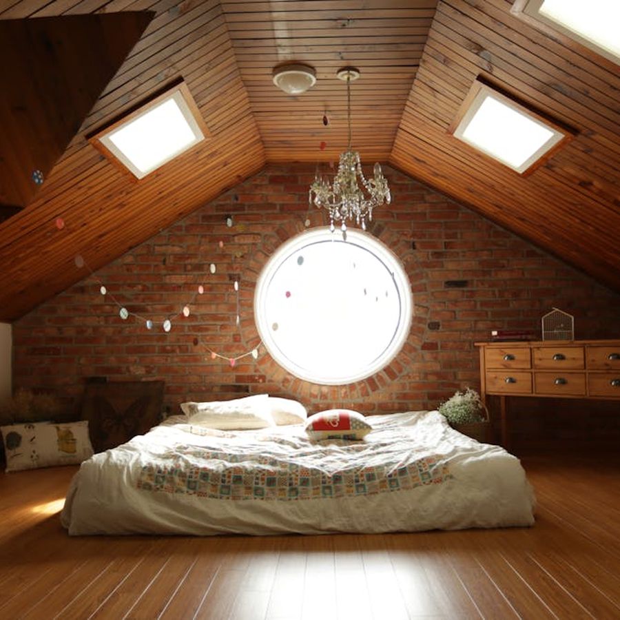 Spacious hotel bedroom with a large comfortable bed and warm lighting
