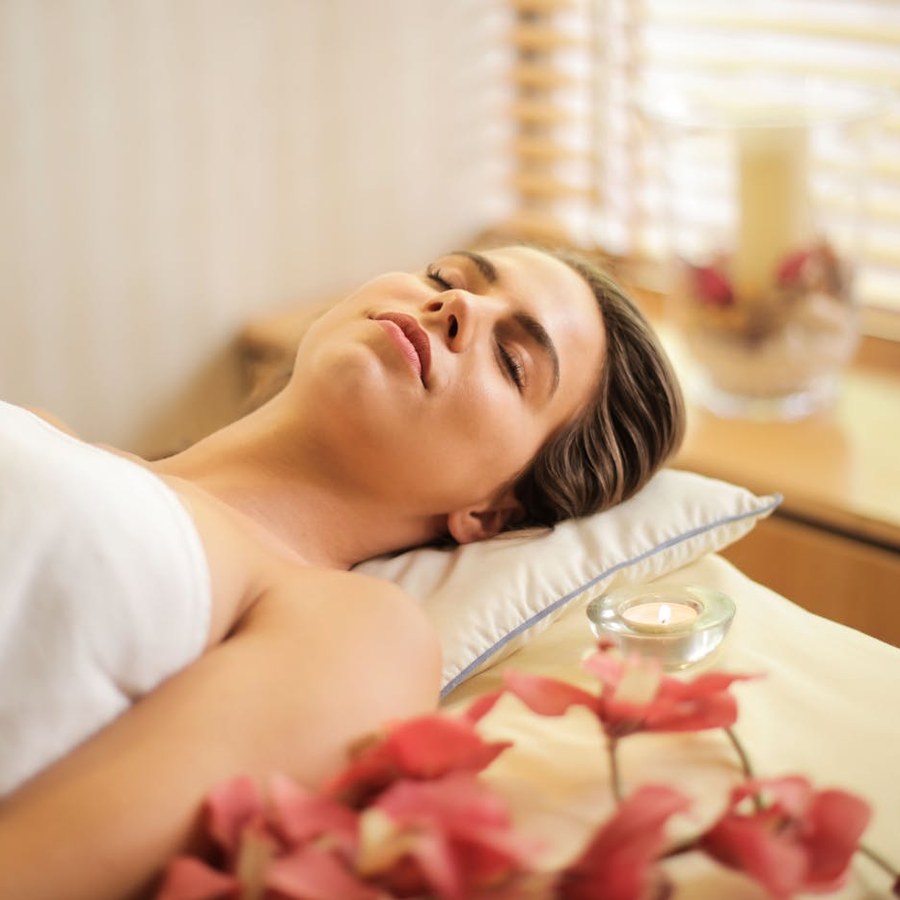Spa still life with smooth hot stones and rolled white towels