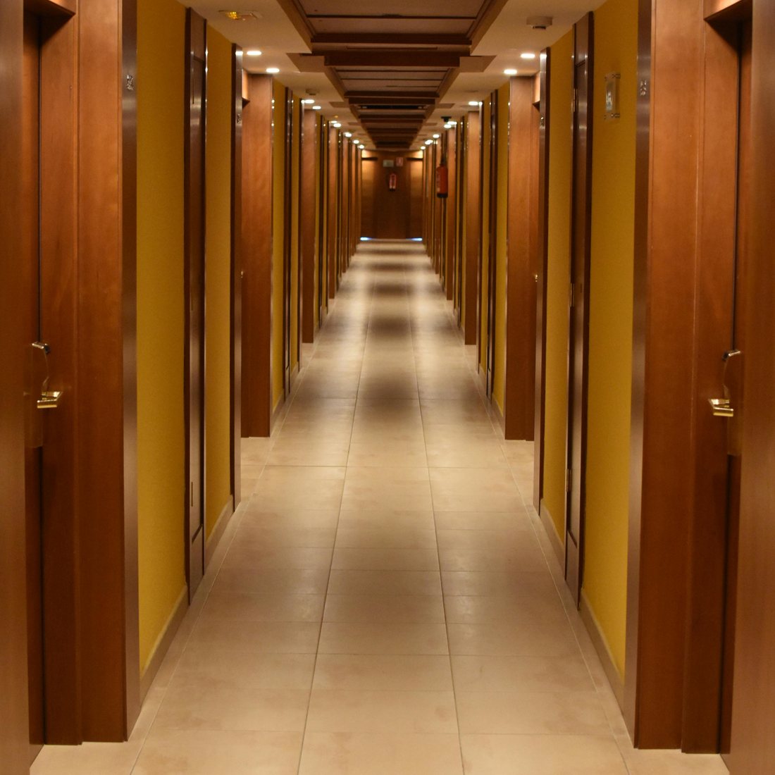 Well-lit hotel corridor with room doors and soft lighting for fast navigation
